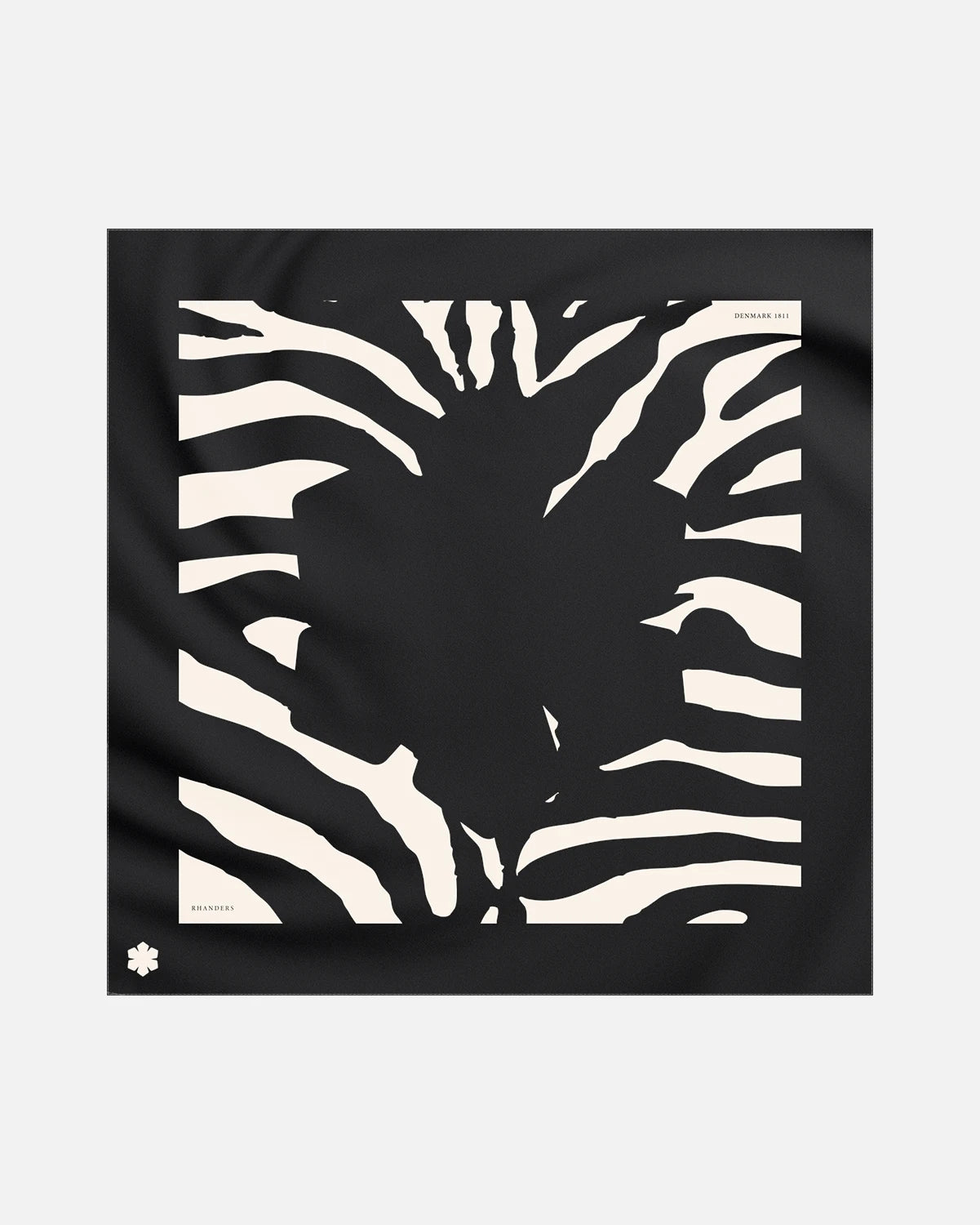 The Aida Zebra Scarf from RHANDERS adorned with a Kalmus and zebra pattern in the hues of black with champagne details.