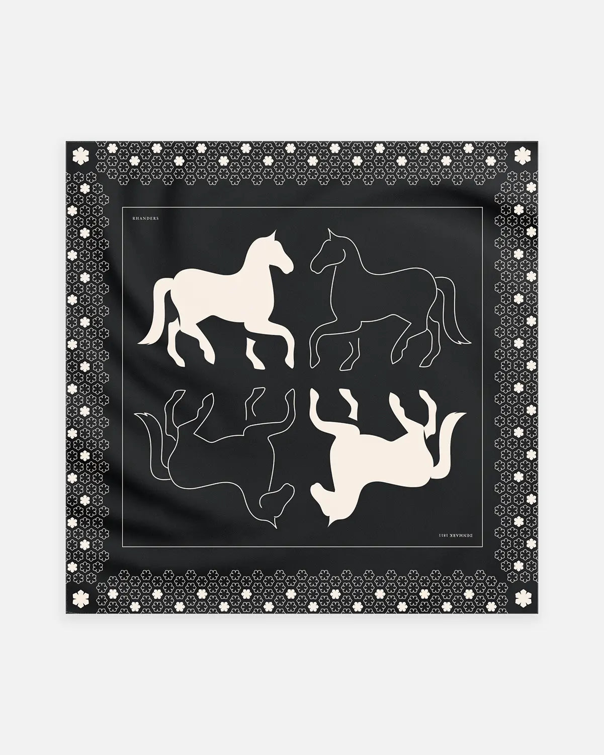 The Cheval Scarf adorned with a horse artwork on a black background with champagne details.