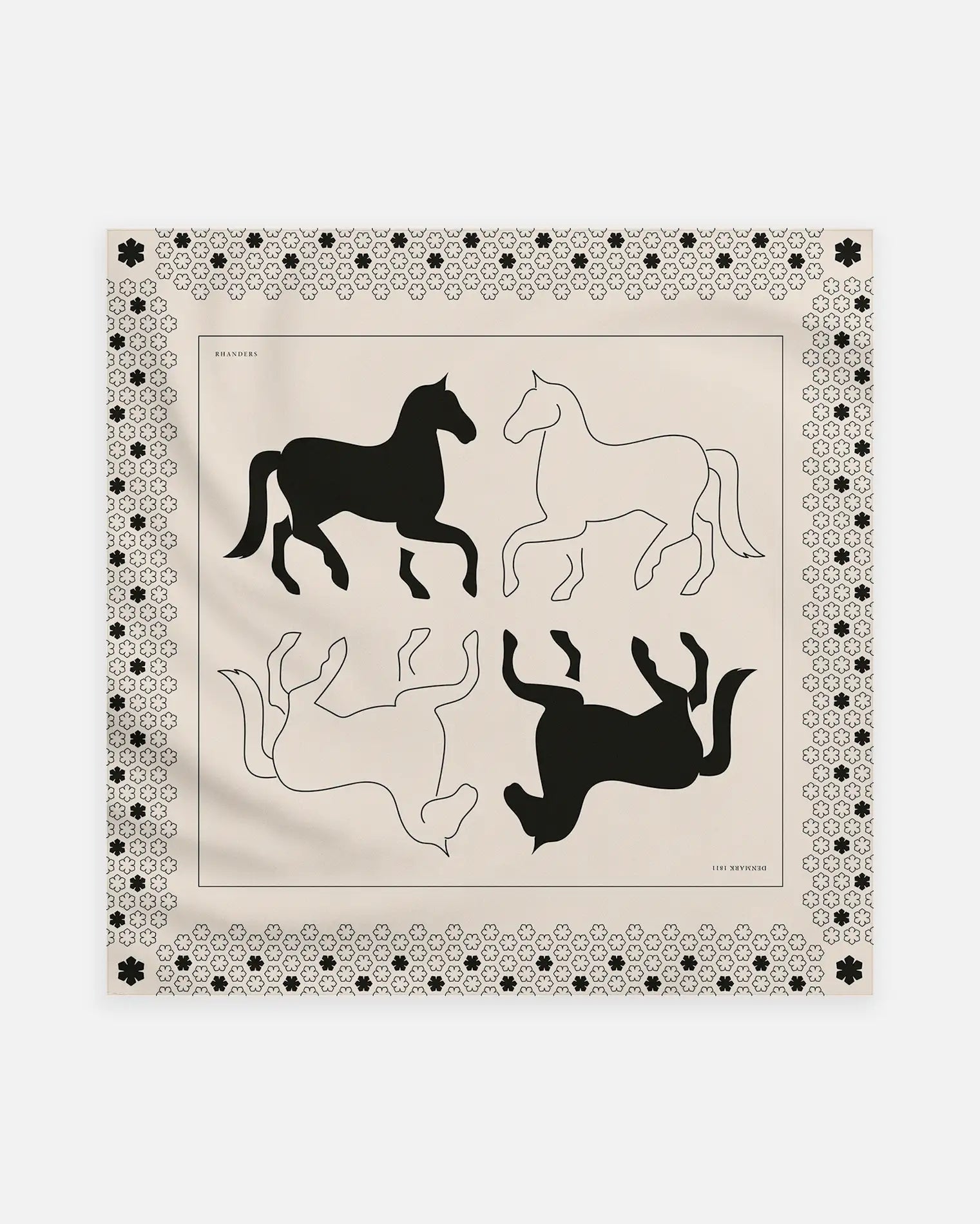 The Cheval Scarf adorned with a horse artwork on a champagne background with black details.