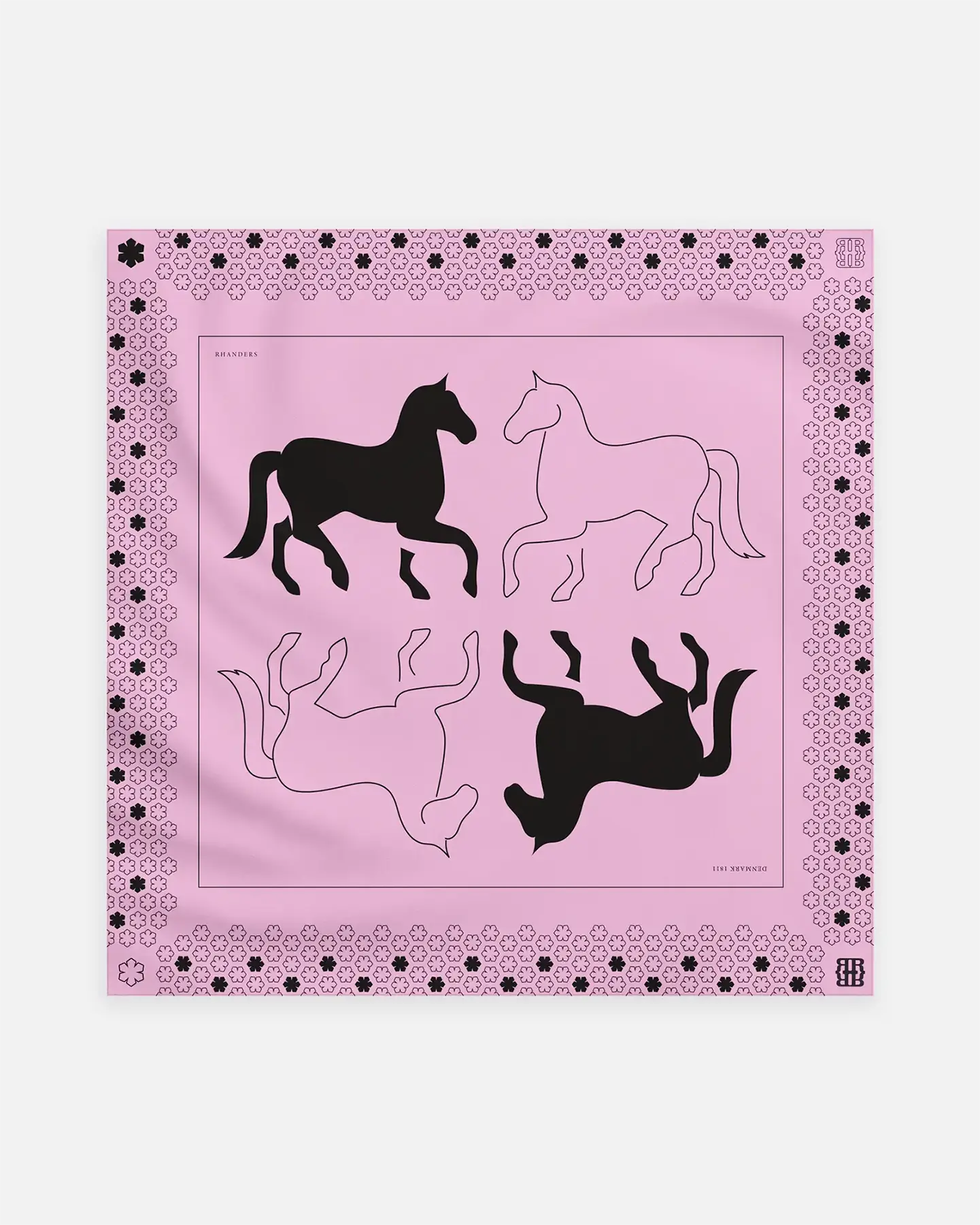 The Cheval Silk Scarf for women from RHANDERS is 100% made from silk and comes in a beautiful rosé colour with black print.