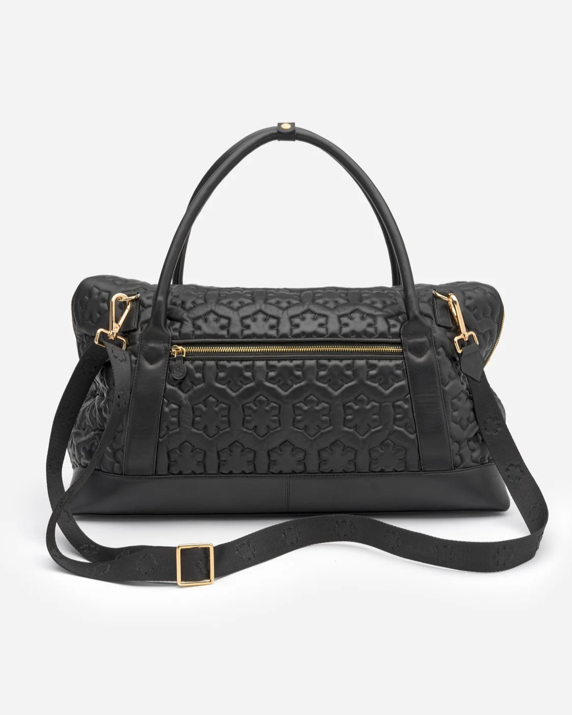 Spacious travel bag from RHANDERS with quilted Kalmus flower shapes, zipper pullers with Kalmus details, and glove leather handles and wide shoulder straps.