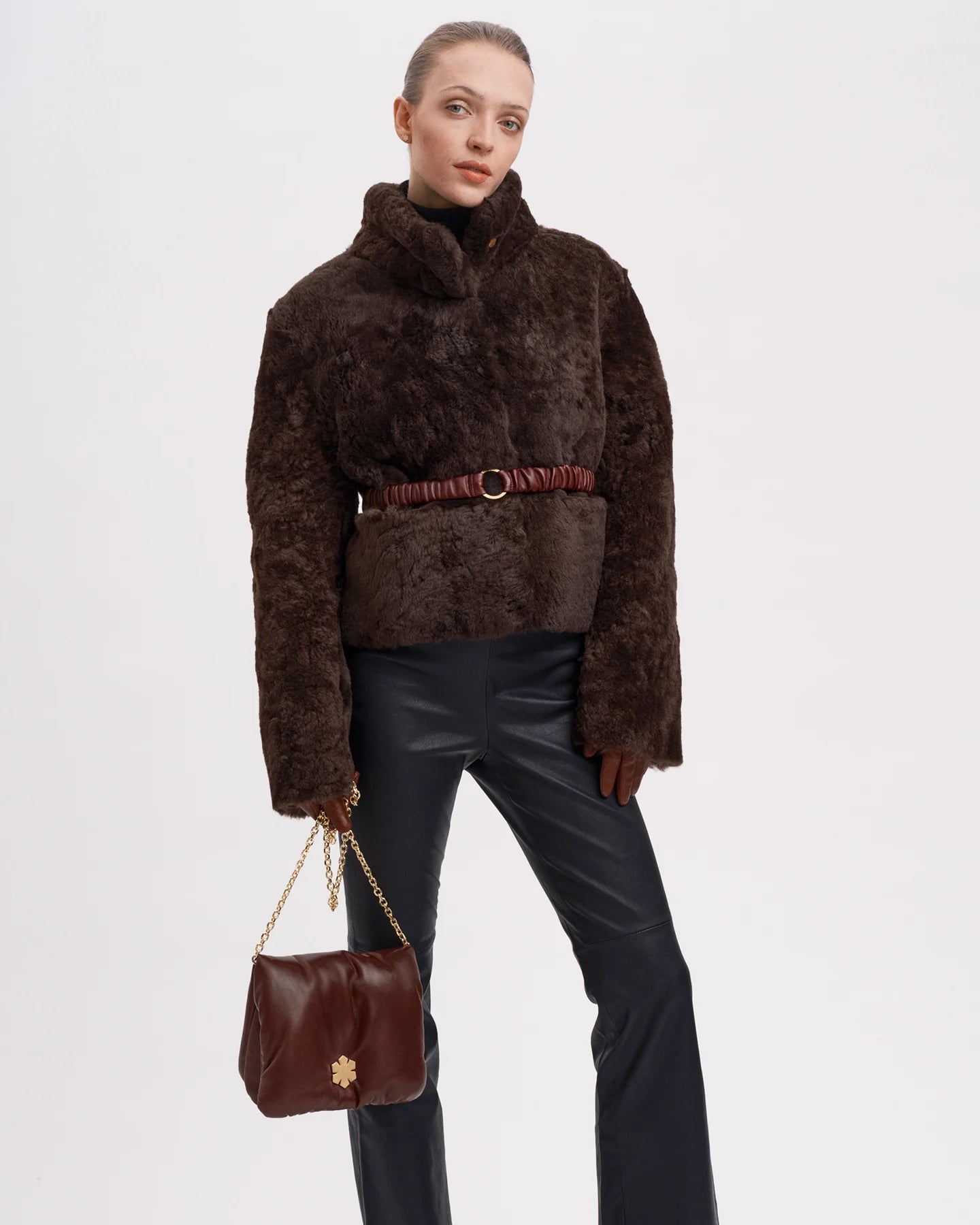 Handcrafted at our atelier in Denmark from upcycled leather with a 14 karat gold plated chain from RHANDERS.