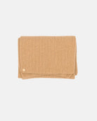 The Alex Scarf in the colour camel adorned with a 14 karat gold-plated Kalmus flower in one corner.