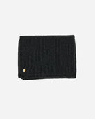 The Alex Scarf in the colour charcoal for women adorned with a 14 karat gold-plated Kalmus flower in one corner.