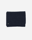 Navy Alex Scarf adorned with a 14 karat hematit-plated Kalmus flower in one corner.