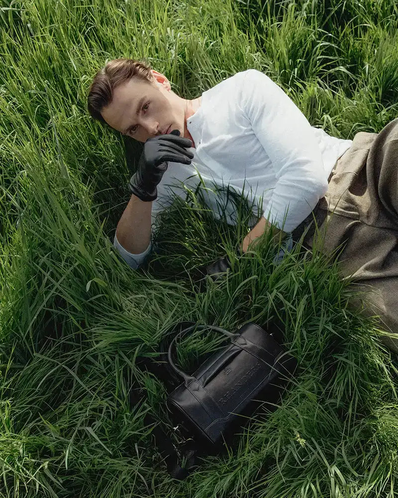 Crown Handbag fra RHANDERS er foret med RH Monogram logo, har inder- samt ydrelommer og er prydet med justerbar Kalmus skulderrem i Kalmus-præget læder og tekstil.