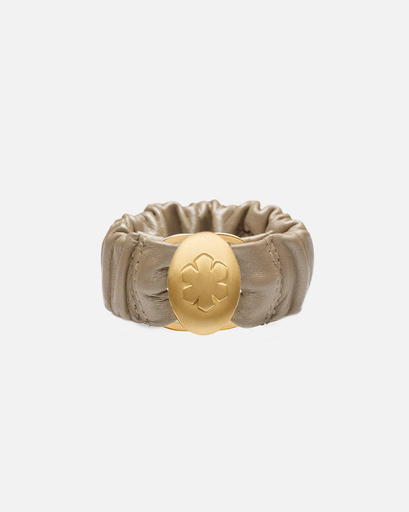 Champagne 'Estelle' bracelet with a gold pleated amulet, embossed with the kalmus flower on the surface, and when opened displays two personal images.