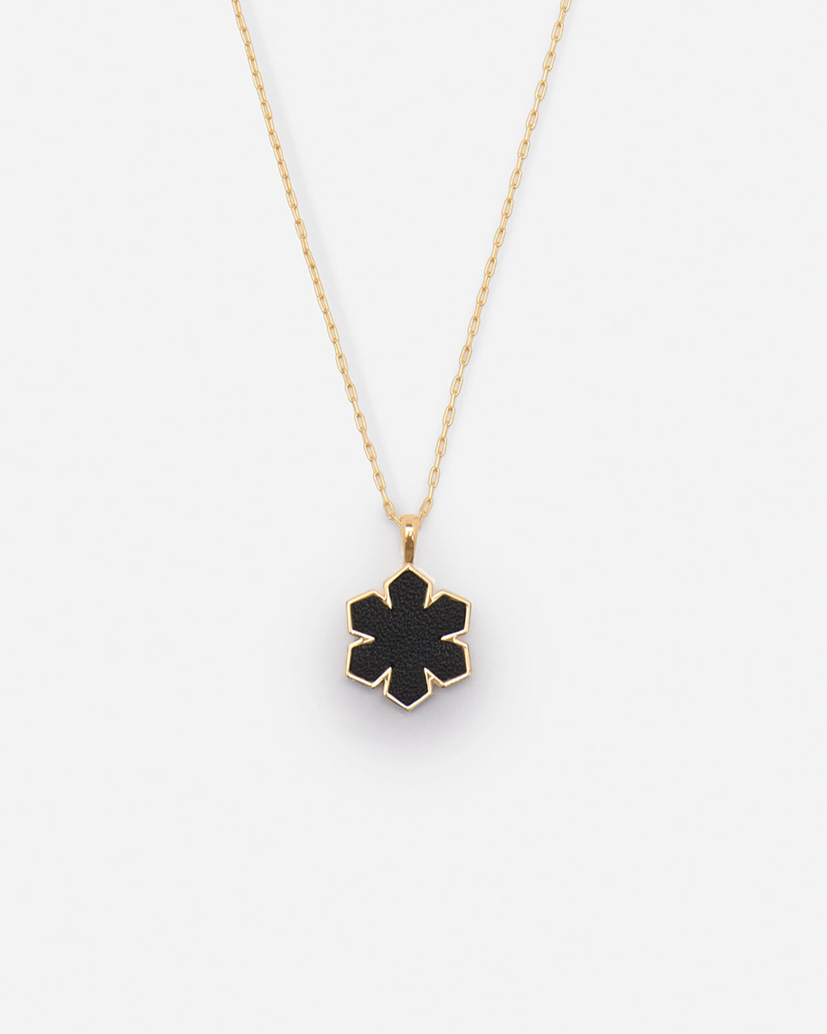 The Leather Fusion Kalmus Necklace is crafted from the finest 14 karat plated gold, adorned with a Kalmus flower with butter-soft glove leather at the center, RHANDERS.