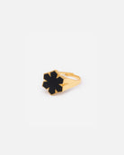 The Leather Fusion Kalmus Ring from RHANDERS is crafted from 14 karat plated gold, adorned with the signature Kalmus flower with butter-soft glove leather at the center.