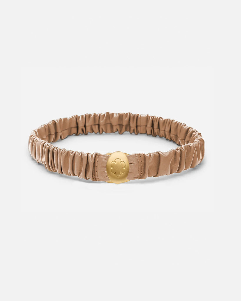 Camel leather belt adorned with a beautiful 14k gold pleated amulet, that stores two images, from RHANDERS.