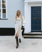 Elegant and timeless coat from RHANDERS, the Tulip Coat - Wool has a sculptural silhouette, curved sleeves, and a double-breasted closure.