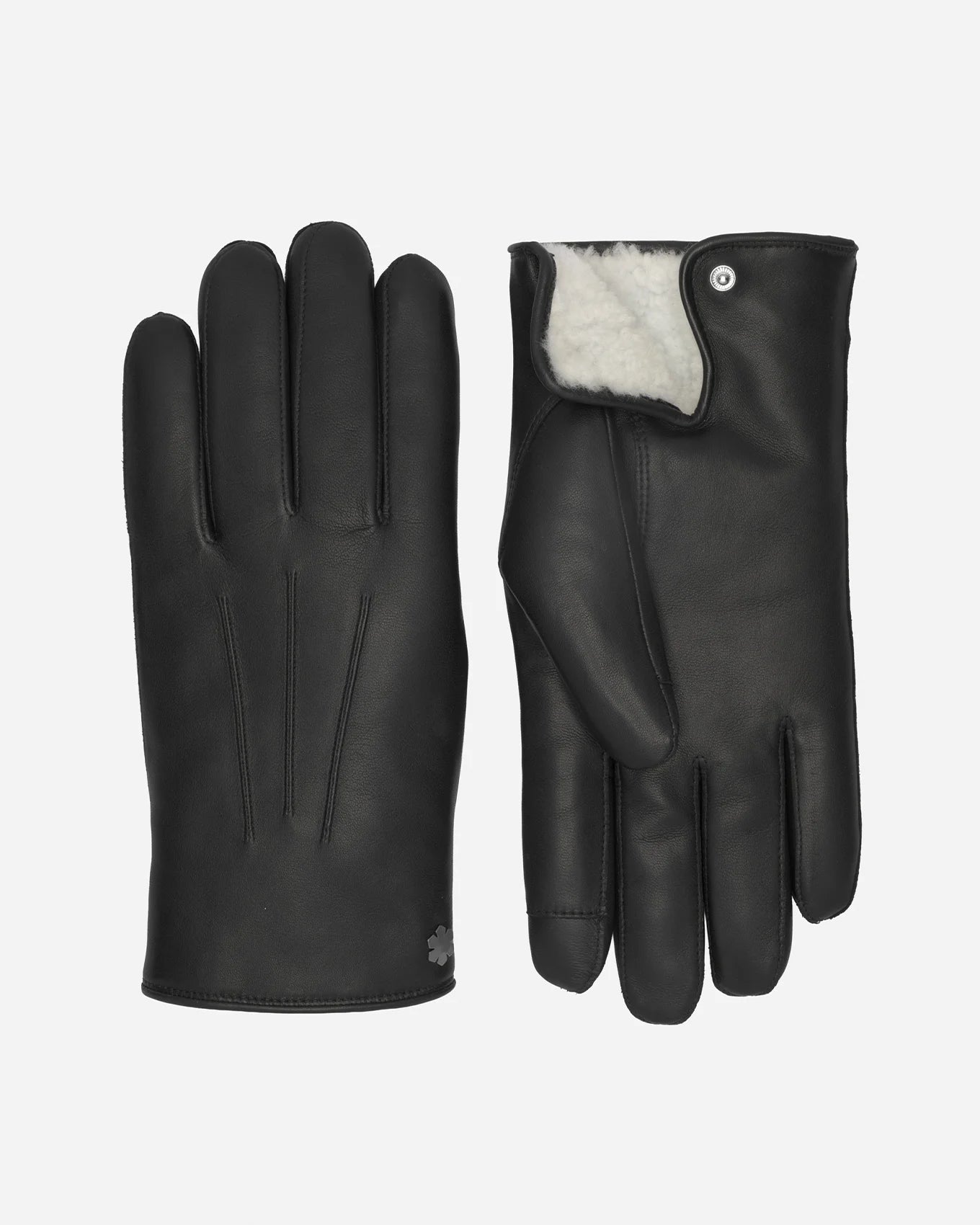 Oplev handsken til herrer Winston Pearl fra RHANDERS, fremstillet i det mest smørbløde lammeskind med varmt perlelamsfor og prydet med en hæmatitbelagt Kalmus blomst.