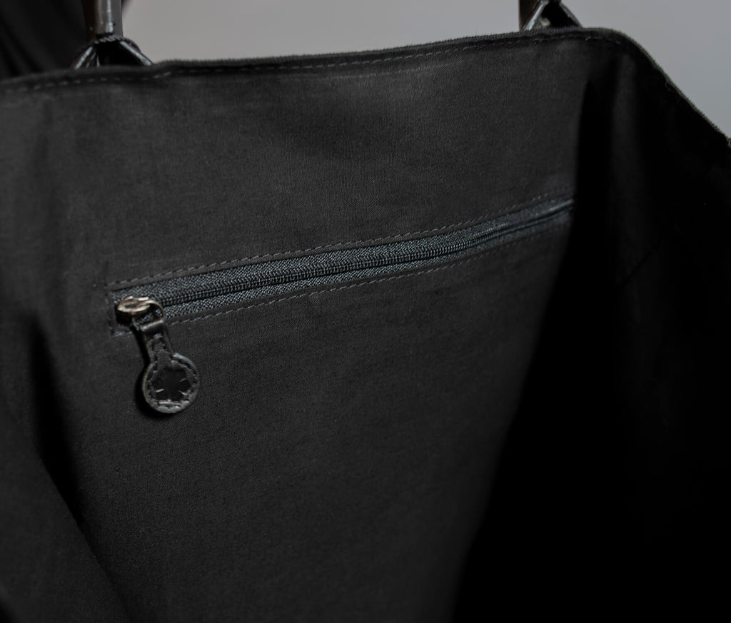 Large black tote bag with room for everything you will need on the go.