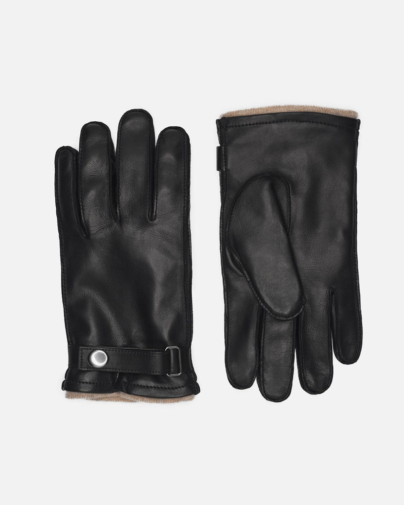 Klassisk herrehandske i sort skind med uldfor, rem og trykknap fra Randers Handsker.