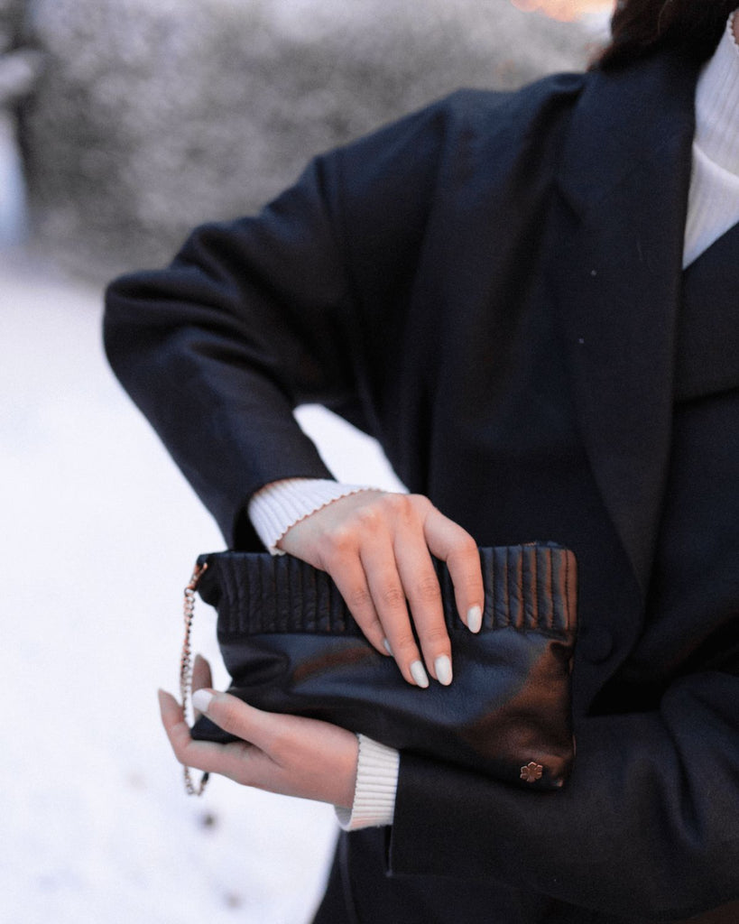 Elegant and handmade designer pouch in the colour black. Crafted from the finest and most exquisite lamb glove-leather, offering a butter-soft touch with an astonishing world-class strength. 