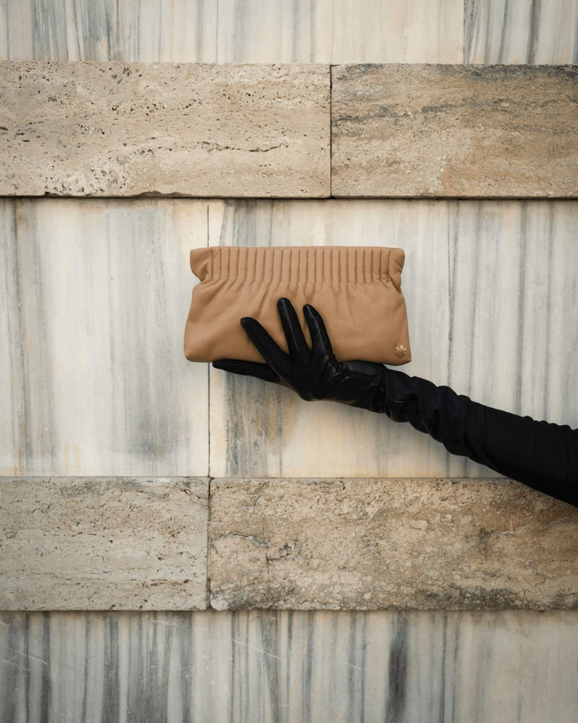 Elegant and handmade designer pouch in the colour camel. Crafted from the finest and most exquisite lamb glove-leather, offering a butter-soft touch with an astonishing world-class strength.