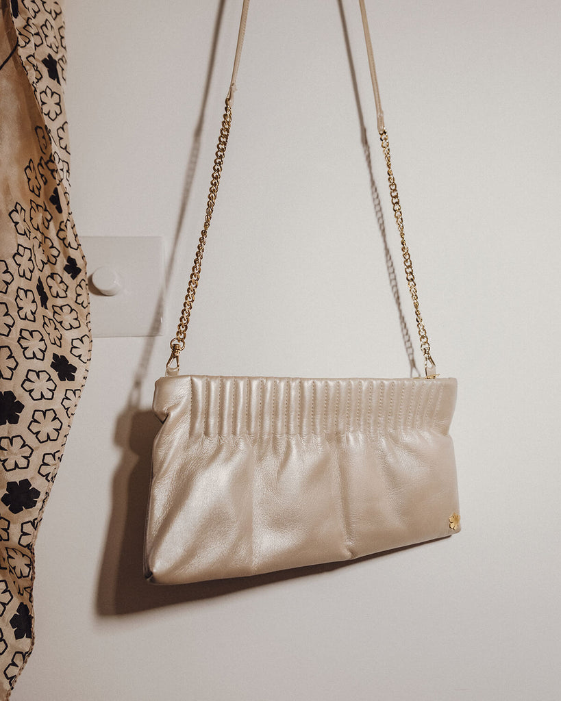 Elegant and handmade designer pouch in the colour champagne metallic. Crafted from the finest and most exquisite lamb glove-leather, offering a butter-soft touch with an astonishing world-class strength.