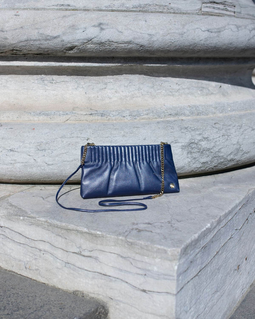 Elegant and handmade designer pouch in the colour royal metallic. Crafted from the finest and most exquisite lamb glove-leather, offering a butter-soft touch with an astonishing world-class strength.