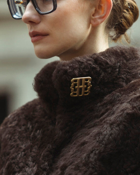 The Helena shearling jacket from RHANDERS accessorized with our timeless RH monogram brooch.